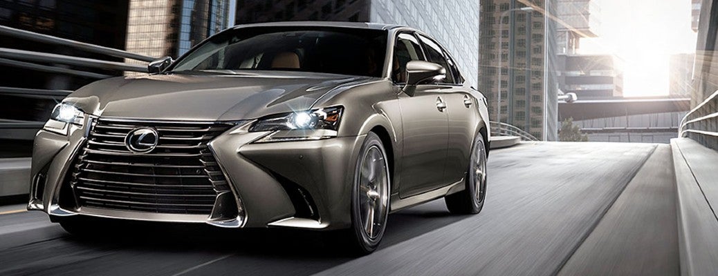A gray 2020 Lexus GS driving down a city road.