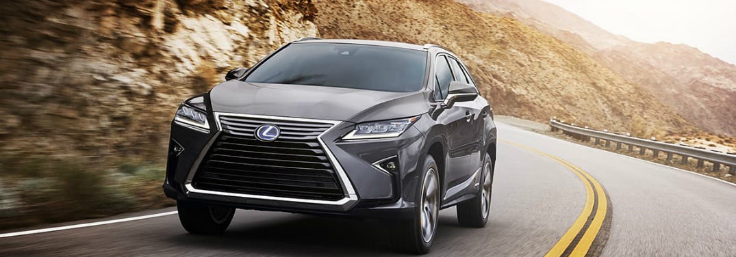 2019 Lexus RX 350 drives around a highway curve.