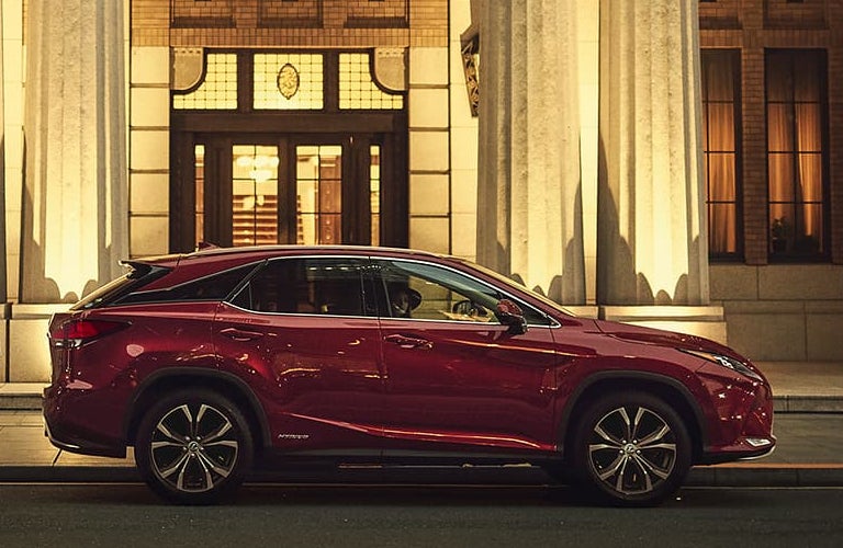 Red 2020 Lexus RX Hybrid on a City Street at Night