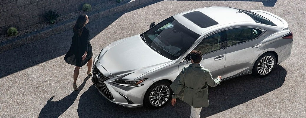 Top down view of a 2022 Lexes ES 300h with a couple walking on either side of it.