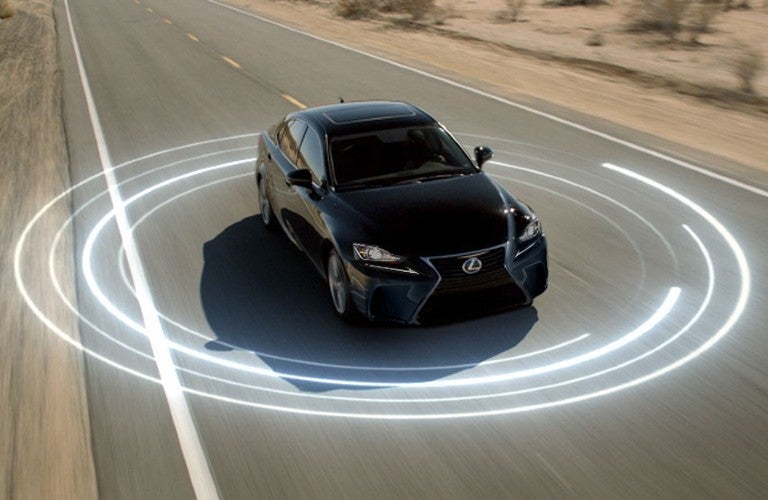 A black 2020 Lexus LC 500 driving on an open road with a circular white lines around it.
