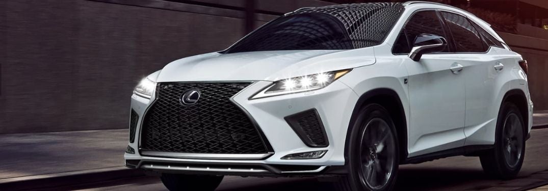 White 2021 Lexus RX on City Street with Headlights Shining