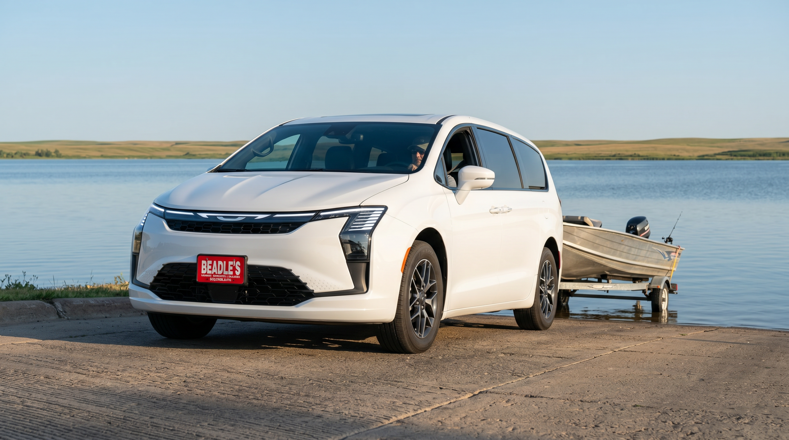 2027 Chrysler Pacifica towing a fishing boat at a South Dakota lake
