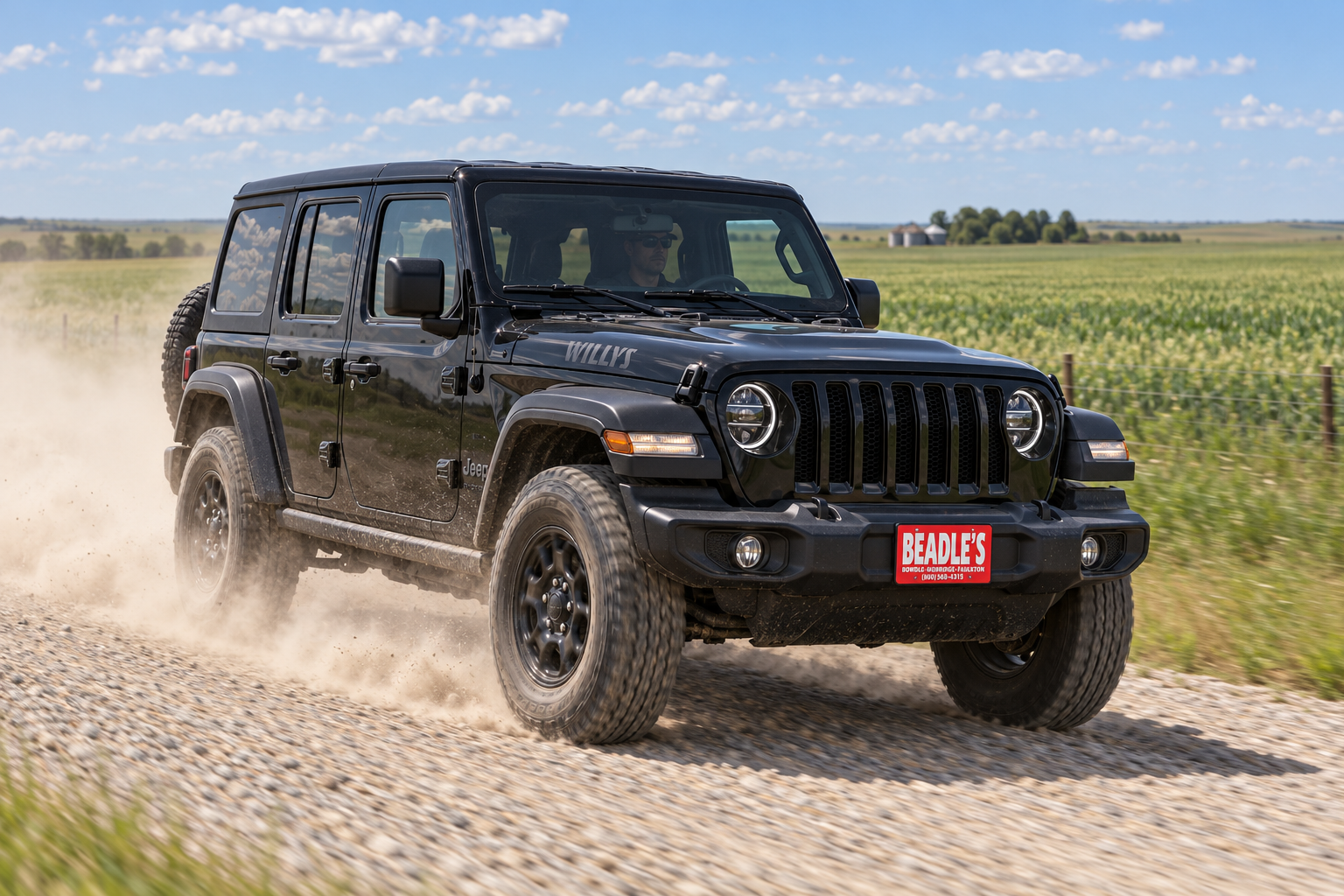 2027 Jeep Wrangler Willys raising dust on a South Dakota gravel section line, at Beadle's Chrysler Center