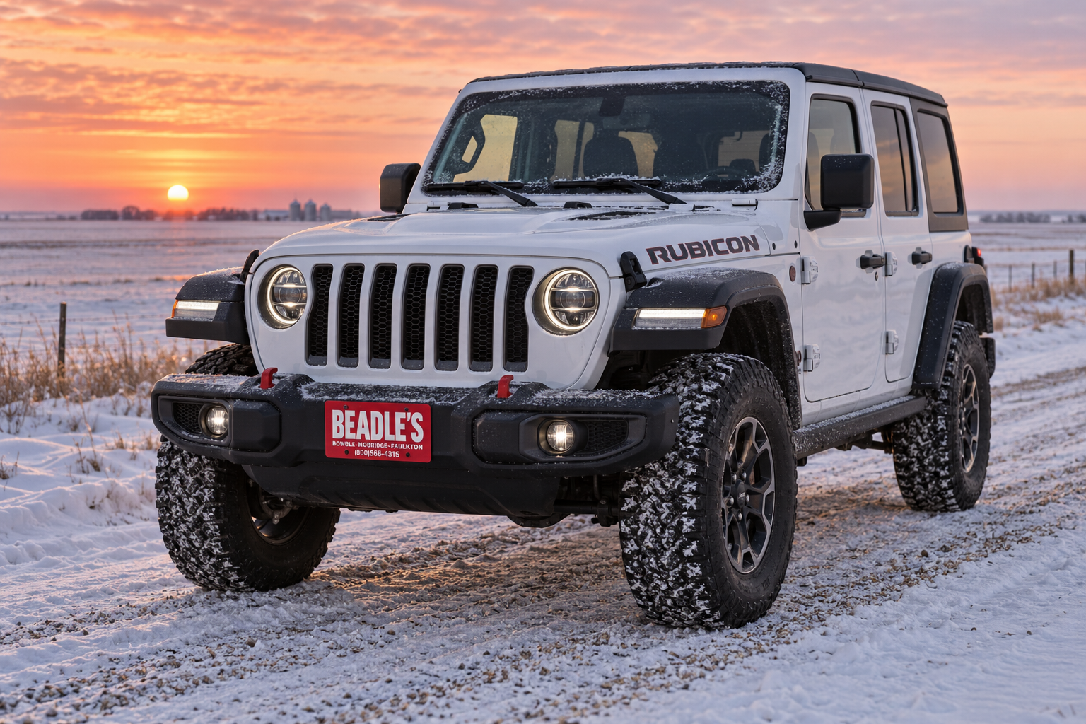 2027 Jeep Wrangler Rubicon at sunrise on a snow-covered South Dakota road, at Beadle's Chrysler Center