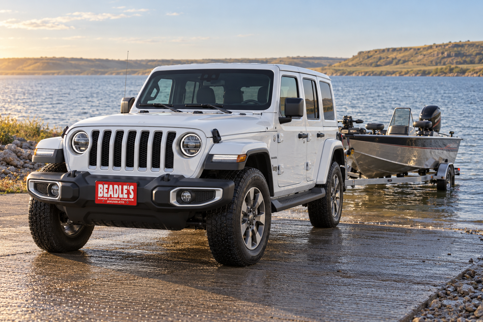 Jeep Wrangler Sahara backing a fishing boat down a Lake Oahe boat ramp in South Dakota, at Beadle's Chrysler Center