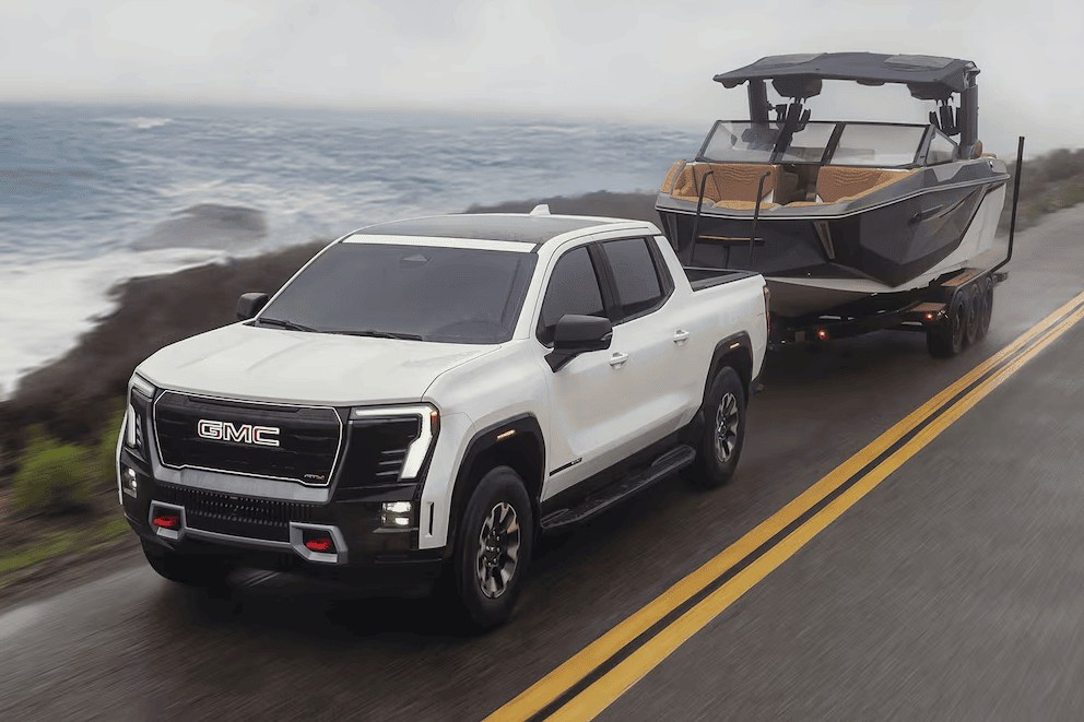 White 2026 GMC Sierra EV towing a boat