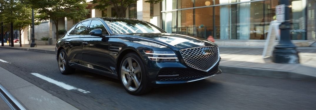 Blue 2021 Genesis G80 Driving on a City Street
