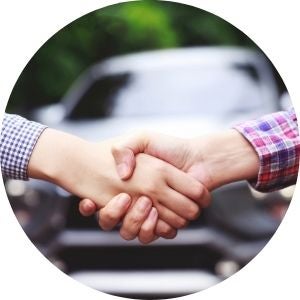 Hands Shaking with a New Car in the Background