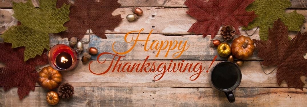 Fall Decor on a Table with Orange and Red Happy Thanksgiving Text
