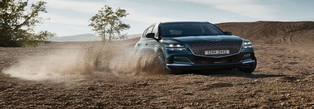 Blue 2021 Genesis GV80 on a Dirt Trail