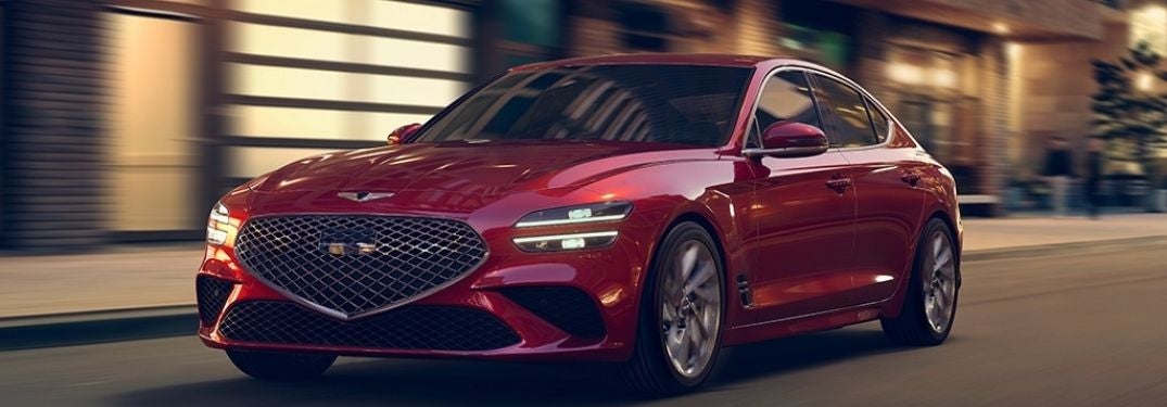 Red 2022 Genesis G70 Front Exterior on a City Street at Night