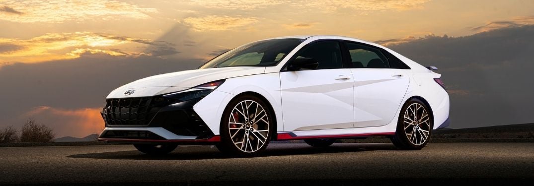 White 2022 Hyundai Elantra N Front Exterior on a Road at Sunset
