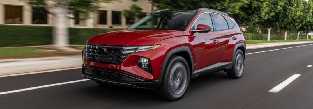 Red 2022 Hyundai Tucson on a City Street