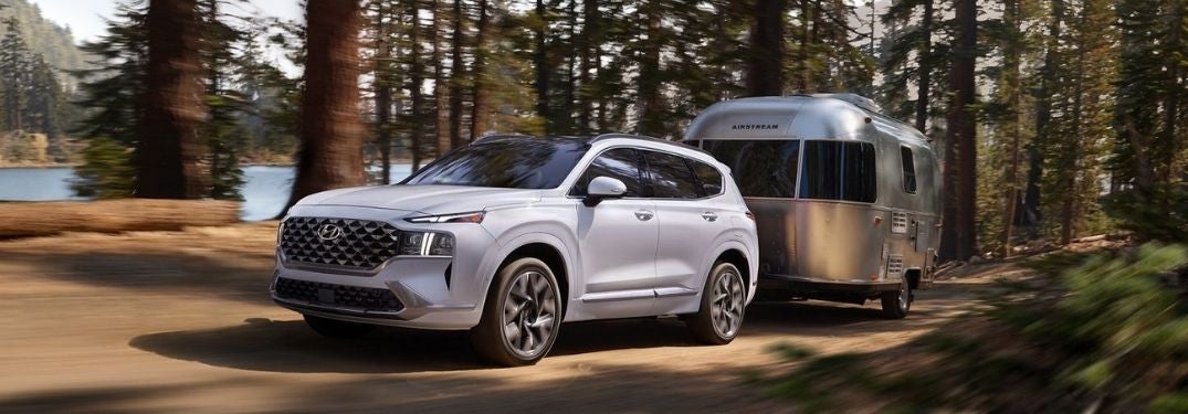 White 2022 Hyundai Santa Fe Towing a Trailer