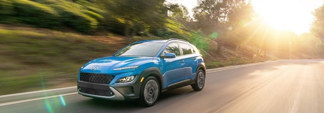 Blue 2022 Hyundai Kona on a Country Highway at Sunset