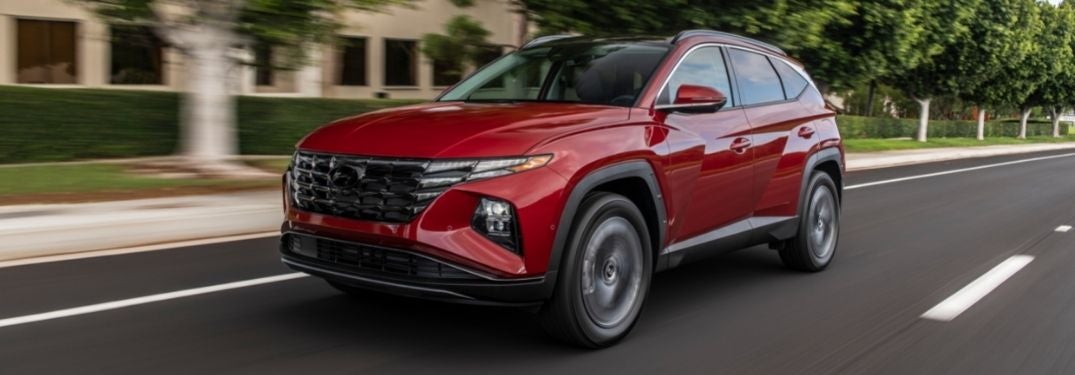 Red 2022 Hyundai Tucson on a City Street