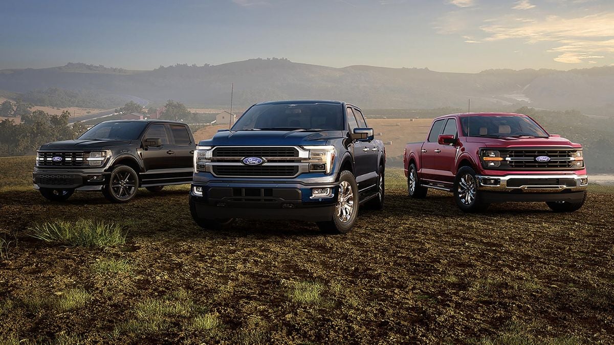 A 2026 Ford F-150 driving through a scenic rural landscape at sunrise