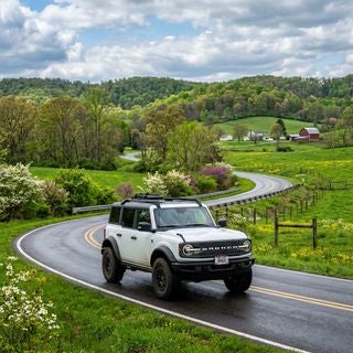 A high-detail, cinematic wide shot of a 2026 Ford Bronco in Ohio during the spring