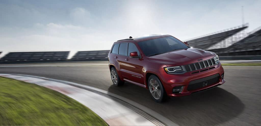 Red Jeep driving on track