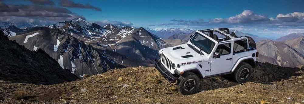 White Jeep on top of Mountain