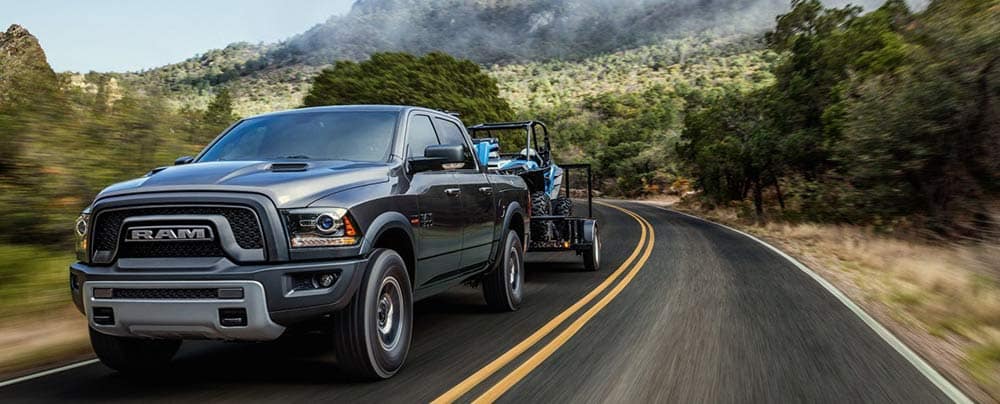 Black Ram truck towing ATV