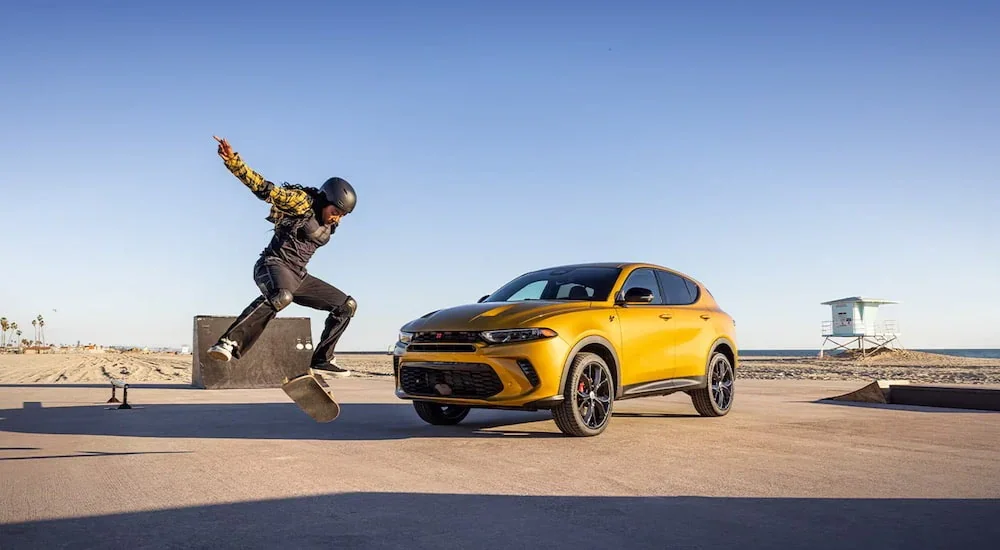 A yellow 2024 Dodge Hornet GT parked at a skate park.