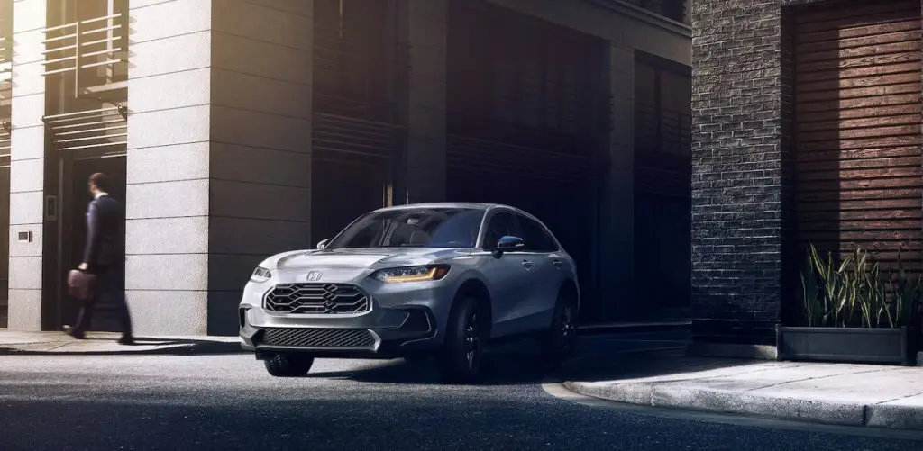 The 2025 Honda HR-V sits parked in an alleyway in a city, making this SUV a perfect city car for you. Shop for your new 2025 HR-V at Stonecrest Honda!