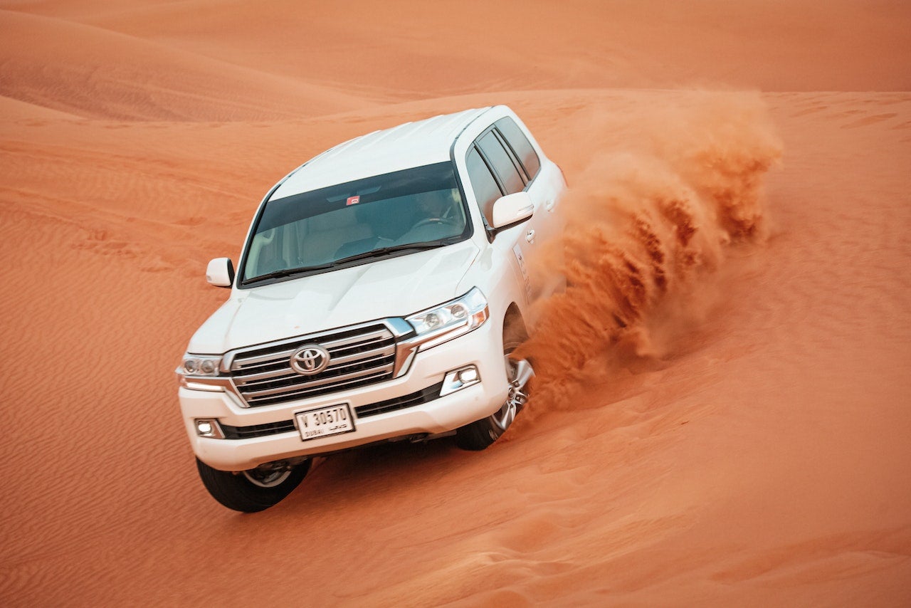 Man Driving a Toyota Car on the Desert