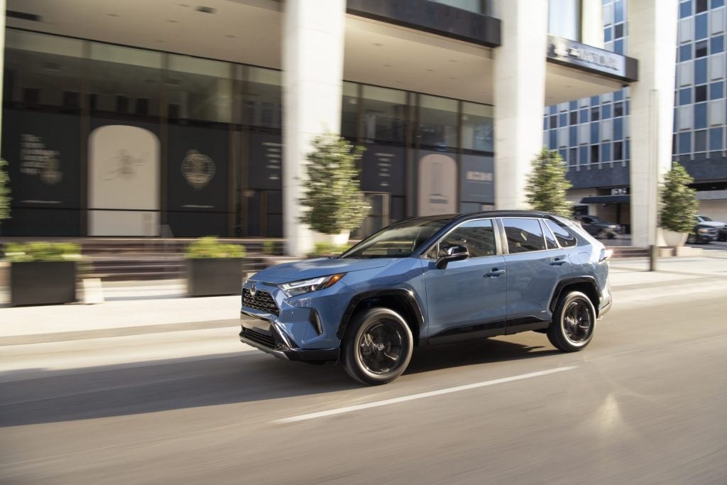 2022_Toyota_RAV4_XSE Driving down a street side profile