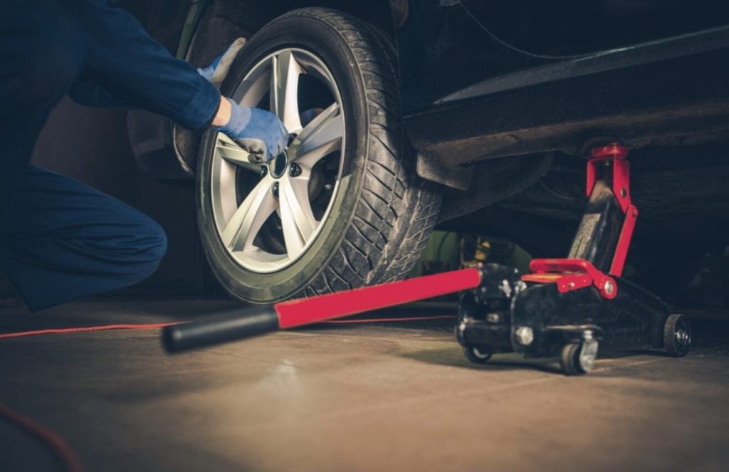 up close shot of a technician performing a tire rotation at North County Ford