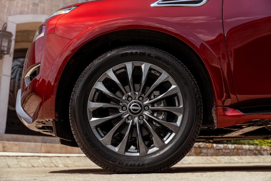 a close up shot of a red nissans front left tire