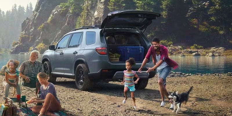 A photo of a 2024 Honda Pilot parked at the beach.