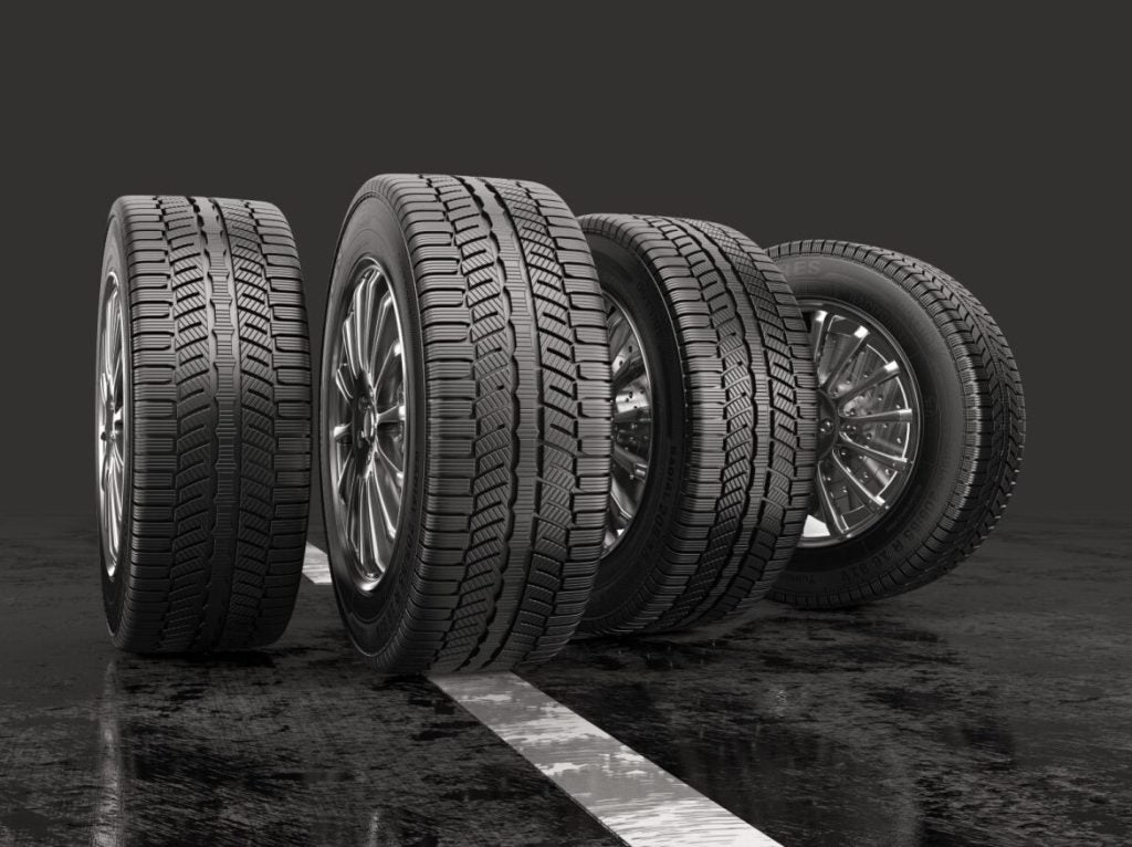 four tires aesthetically set up side by side on a show floor.