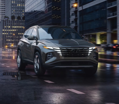 2024 Hyundai Tucson driving through a city at night near Dublin, CA.