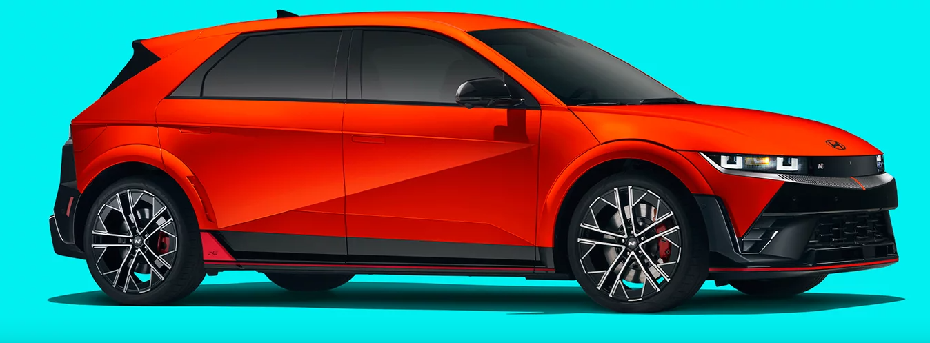 2025 Ioniq 5 N in orange paint against a blue cyan background.