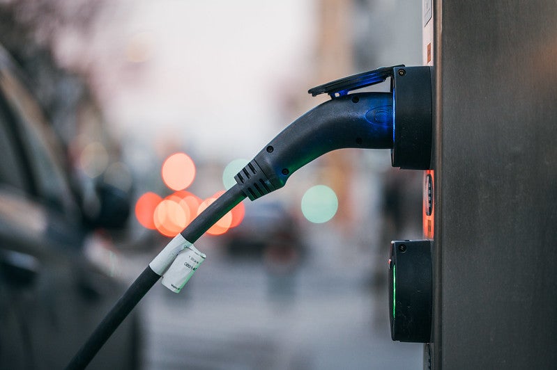 A charging station seen from the side plugged into its unit