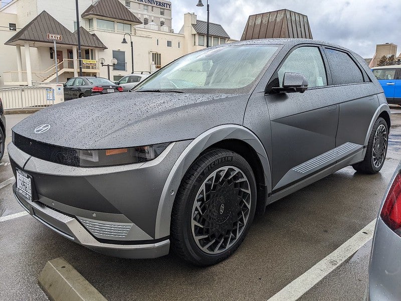 The Hyundai IONIQ 5 in a parking lot in the rain