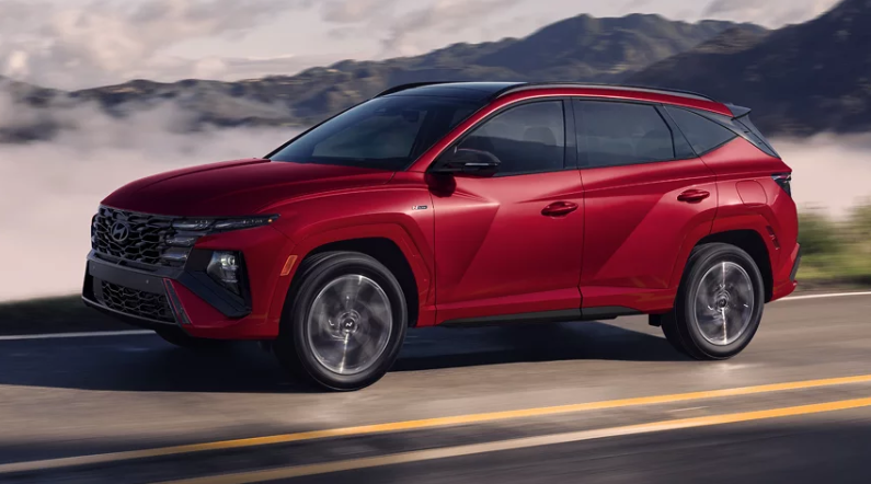 2025 Hyundai Tucson Hybrid in red paint driving in a foggy California highway.