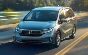 A 2024 Honda Odyssey driving down a street near Ontario, California.