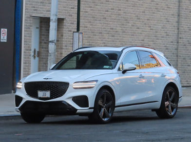 Genesis GV70 in white paint parked outside a Dublin, CA service center.
