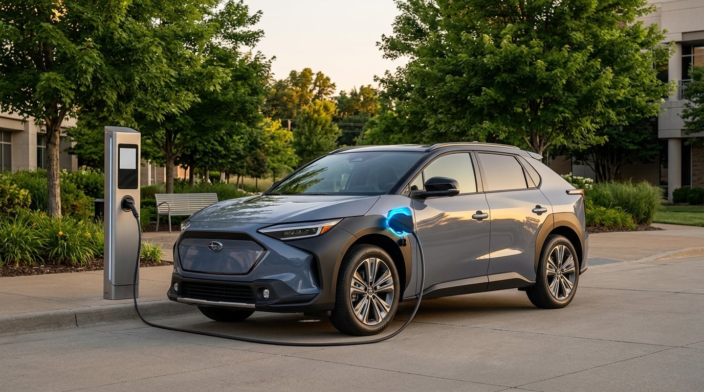 A gray Subaru Solterra electric SUV parked and charging at a modern public EV charging station. (Representative image for illustration purposes only. Actual vehicle may vary based on trim and configuration.)
