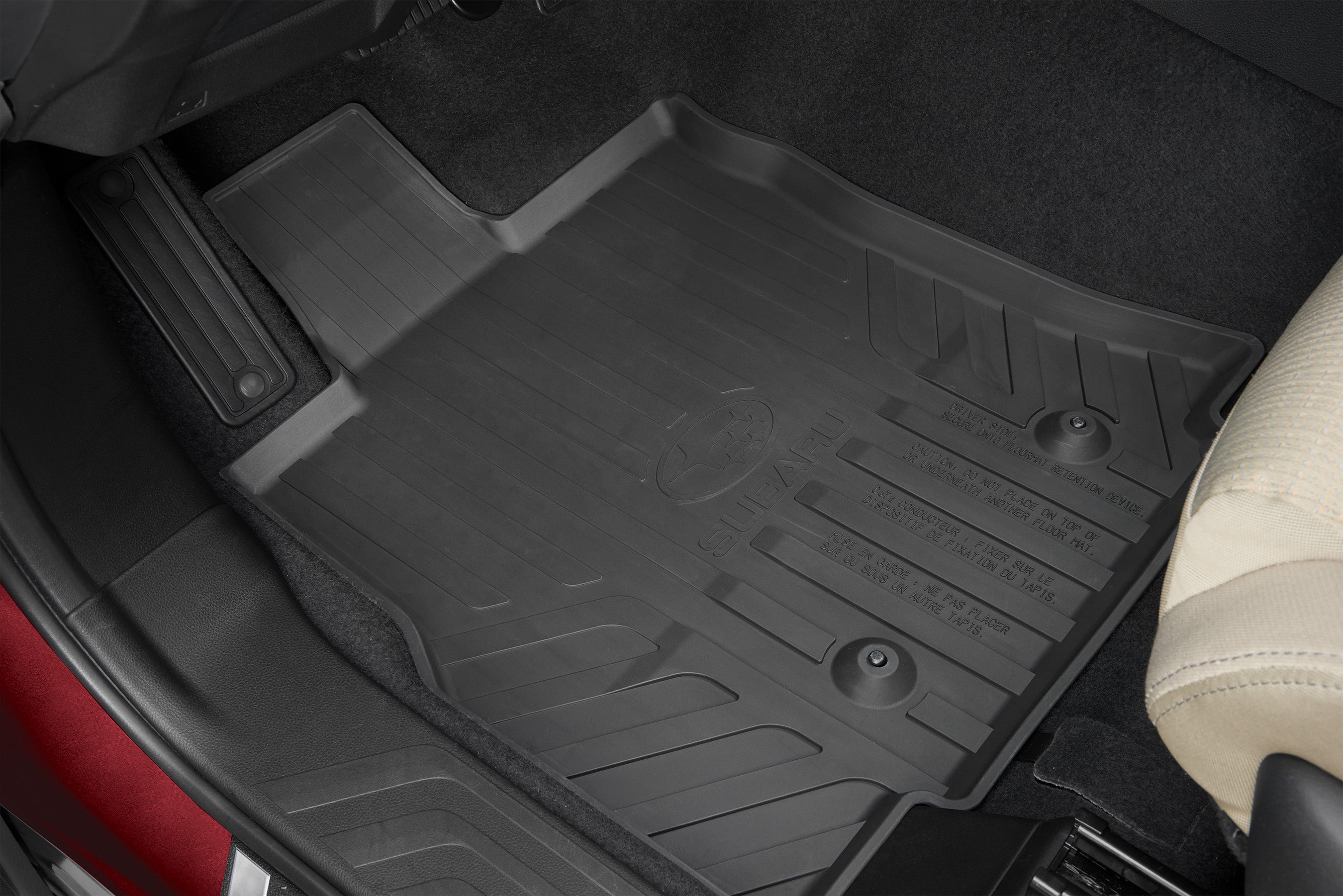 Black Subaru all-weather rubber floor mat installed in the driver's side footwell of a car.