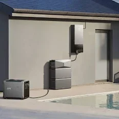 Outdoor home battery storage system and portable power station linked next to a swimming pool.