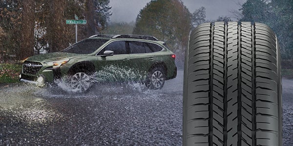 A 2019 Subaru Forester driving through a scenic Missouri road showcasing tire grip and AWD stability.