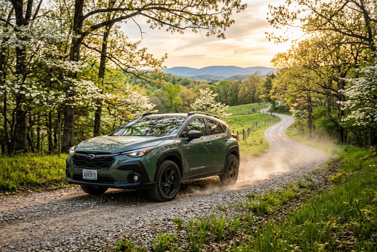 A new Subaru Crosstrek navigating a scenic Missouri trail during spring.