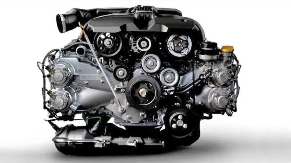 Shiny car engine with belts and pulleys, on a white background.