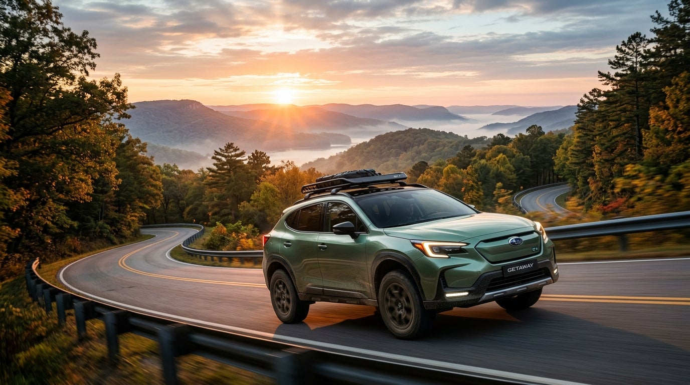 AI generated: Cinematic wide shot of a futuristic 2027 Subaru Getaway EV traversing a winding mountain pass in the Missouri Ozarks at sunrise, a sleek yet rugged electric SUV with high ground clearance, large all-terrain tires, and a minimalist roof rack, glowing c-shaped LED signature headlights, pearlescent forest green paint catching the warm golden hour light, low-angle perspective emphasizing its capability, mist rising from the valley below, dense oak and pine trees lining the asphalt road, vibrant morning sky with hues of orange and soft blue, photorealistic style, sharp focus on the vehicle's aerodynamic body, high-resolution advertising photography, serene and adventurous mood.