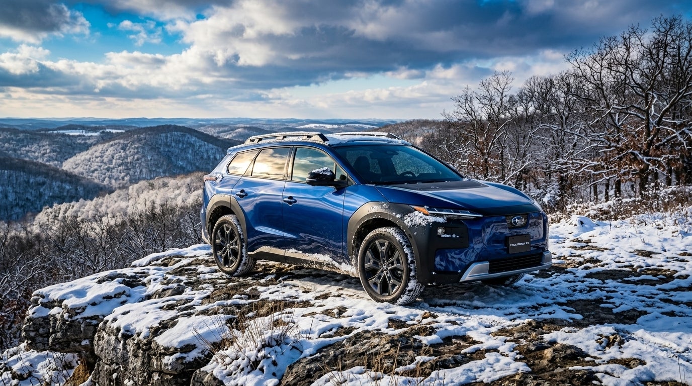 AI generated: Commercial photography, eye level, a rugged 2026 Subaru Trailseeker electric SUV parked on a snowy limestone overlook in the Missouri Ozarks near Sunset Hills, the vehicle's metallic exterior reflecting the dramatic high-contrast winter sunlight, dusting of fresh white snow on the rolling hills and dormant oak trees in the background, vibrant and saturated color palette with deep blues in the shadows and bright white highlights, Missouri winter atmosphere, heavy snowfall clinging to the vehicle's fenders and the rocky terrain, wide-angle lens capturing the expansive horizon of the Mark Twain National Forest, majestic and adventurous mood, crisp and sharp details, advertising style.