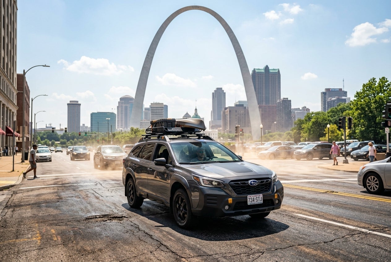 AI generated: A dramatic photorealistic Subaru Outback driving through downtown St. Louis during an intense summer heatwave. The iconic Gateway Arch rises in the background while visible heat waves shimmer above sun-scorched asphalt. The roadway appears to radiate extreme heat, illustrating temperatures exceeding 140 degrees Fahrenheit. The Subaru remains composed and reliable despite the challenging conditions. Cinematic sunlight, realistic atmospheric haze, ultra-detailed vehicle reflections, professional automotive advertising photography, HDR lighting, magazine-quality image, 8K resolution, highly realistic summer environment.